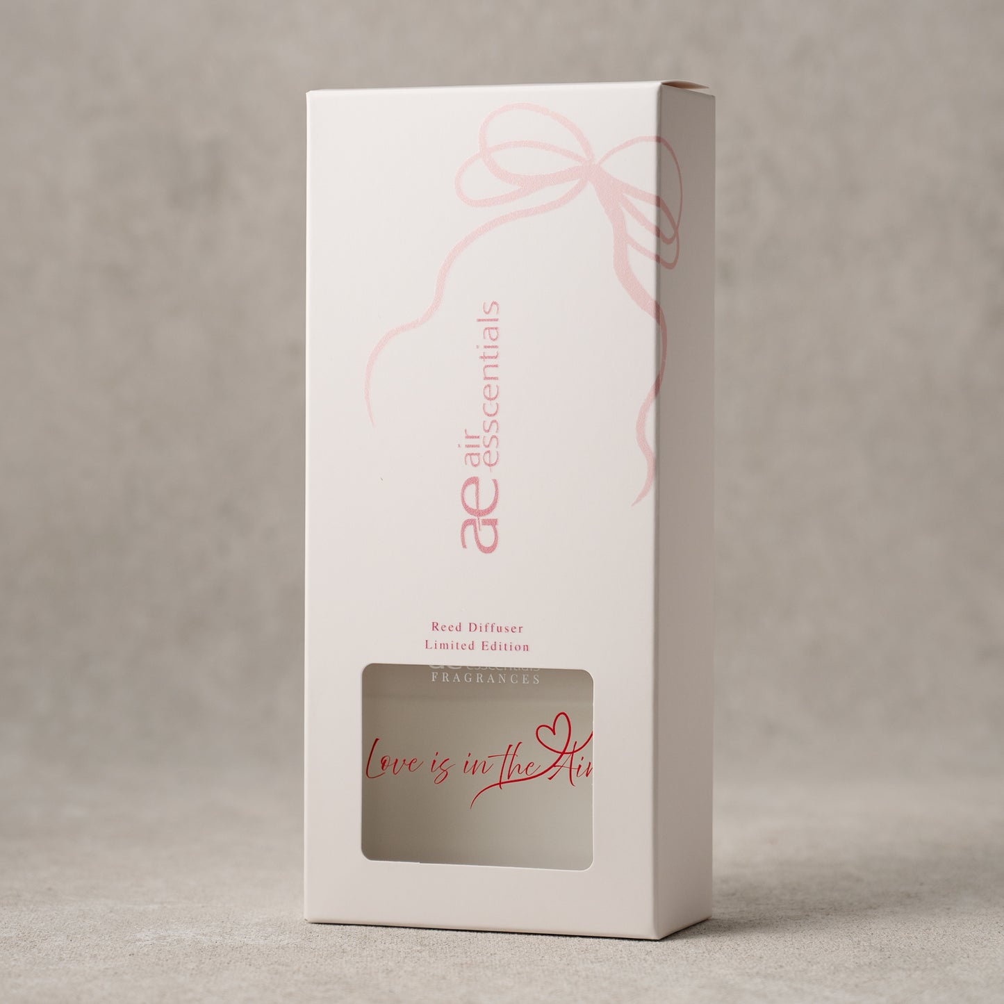 White box with pink text and design on a gray background