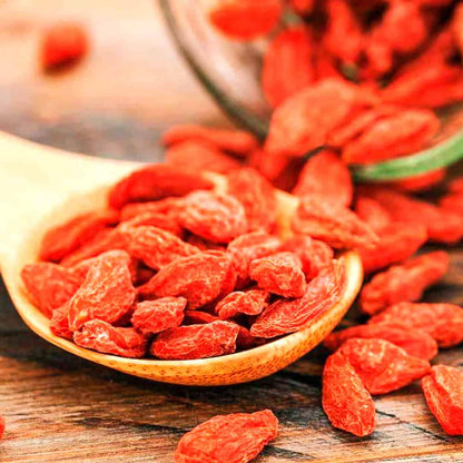 Dried goji berries on a wooden spoon, inspired by sparkling goji berry room spray scent