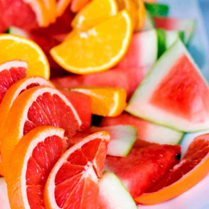 Sliced oranges, grapefruit, and watermelon arranged on a plate