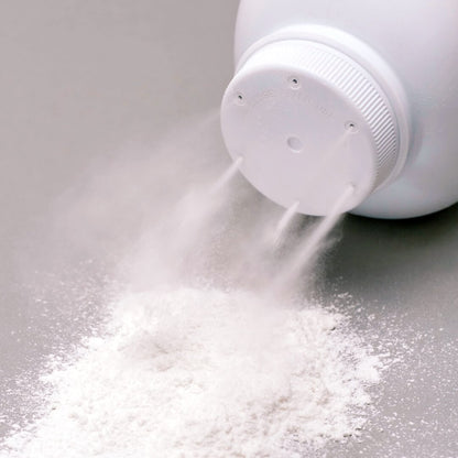 White powder pouring from shaker bottle, representing white tea scent diffuser fragrance