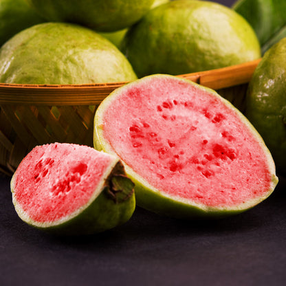 Fresh sliced guava fruit with pink flesh, evoking tropical green tea lemongrass fragrance notes