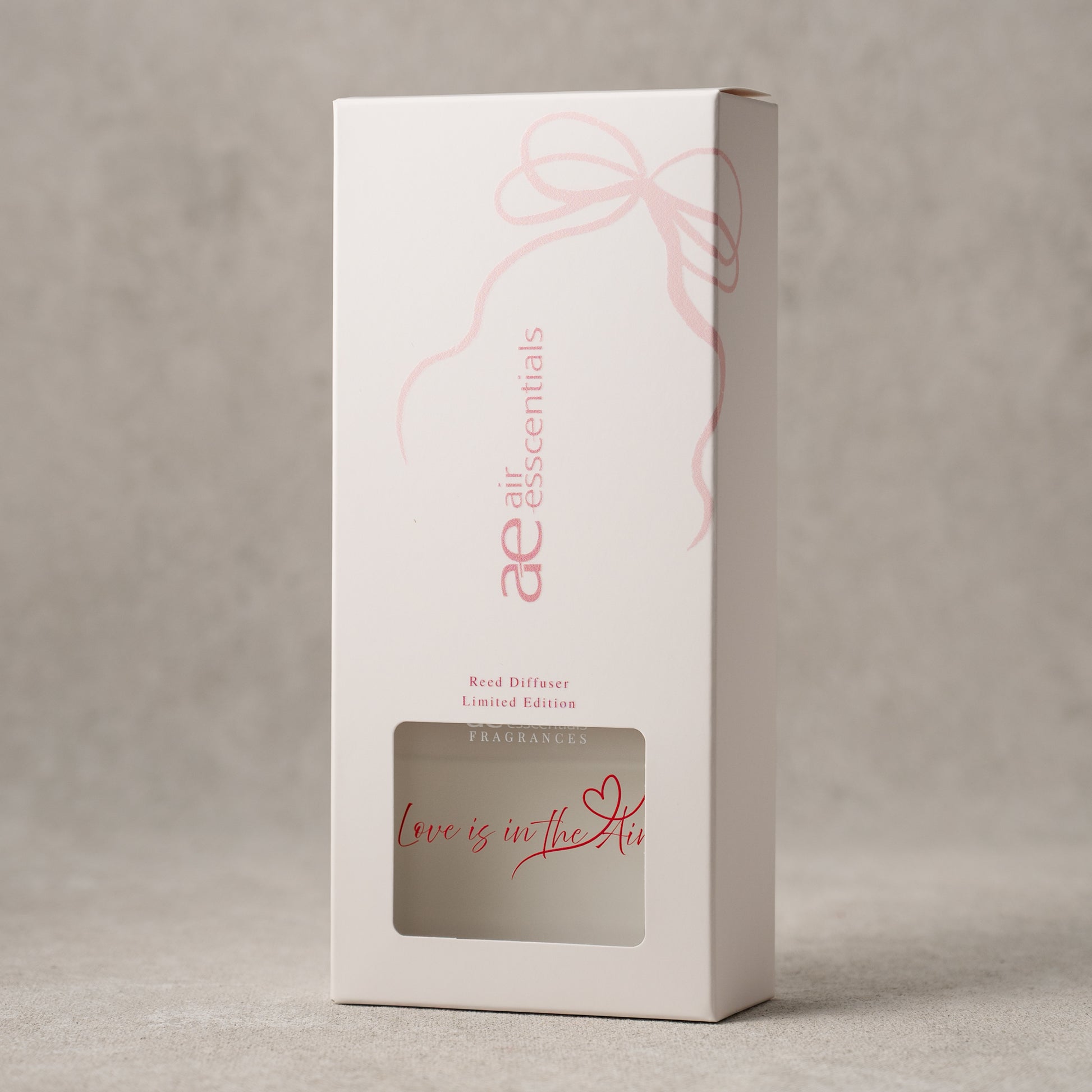 White box with pink text and design on a gray background