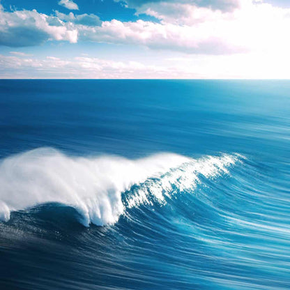 Bright blue ocean wave under sunny sky, evoking fresh blue scent